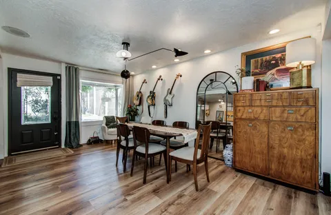 a view of a dining room with furniture and wooden floor