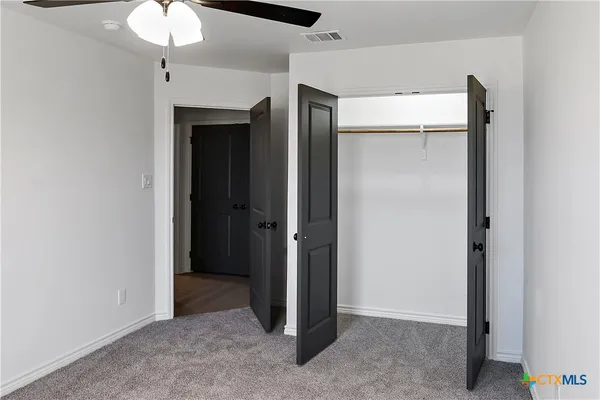 a view of an empty room with a bathroom