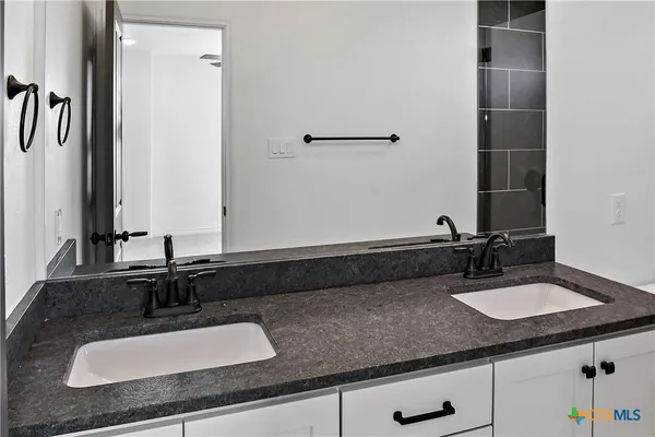 a bathroom with a sink and a mirror