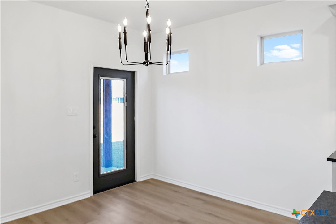 1408 Rita Blanca Court Temple, TX 76502 - Photo 3 of 17 a view of a hallway with wooden floor and chandelier