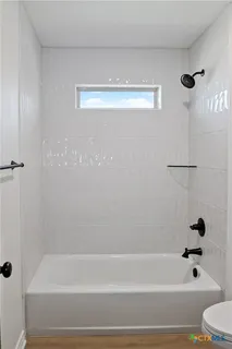 a bathroom with a shower and a bathtub