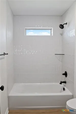 a bathroom with a shower and a bathtub