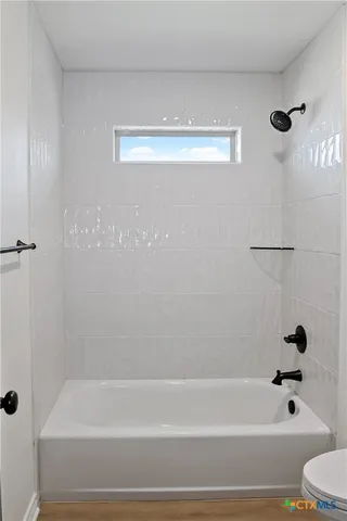 a bathroom with a shower and a bathtub
