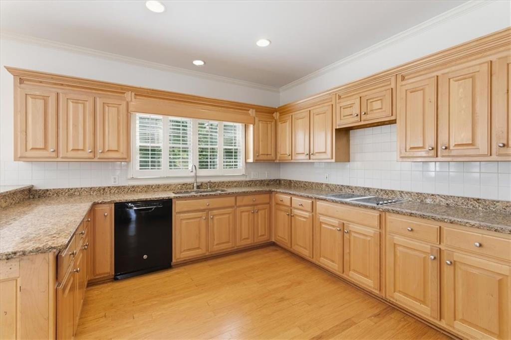 2021 Cockrell Pointe Northwest Kennesaw, GA 30152 - Photo 17 of 59 a kitchen with granite countertop cabinets stainless steel appliances a sink and a window