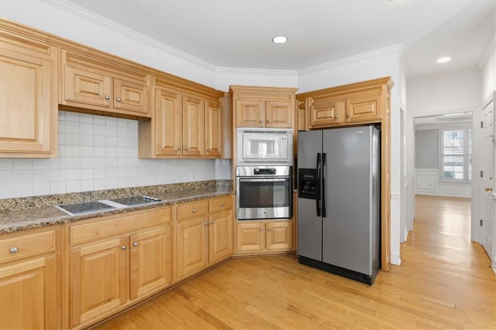 2021 Cockrell Pointe Northwest Kennesaw, GA 30152 - Photo 19 of 59 a kitchen with stainless steel appliances granite countertop a refrigerator and a stove top oven