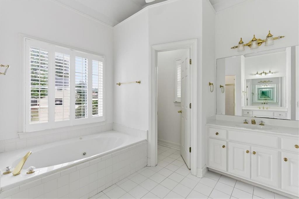 2021 Cockrell Pointe Northwest Kennesaw, GA 30152 - Photo 31 of 59 a bathroom with a tub sink and mirror