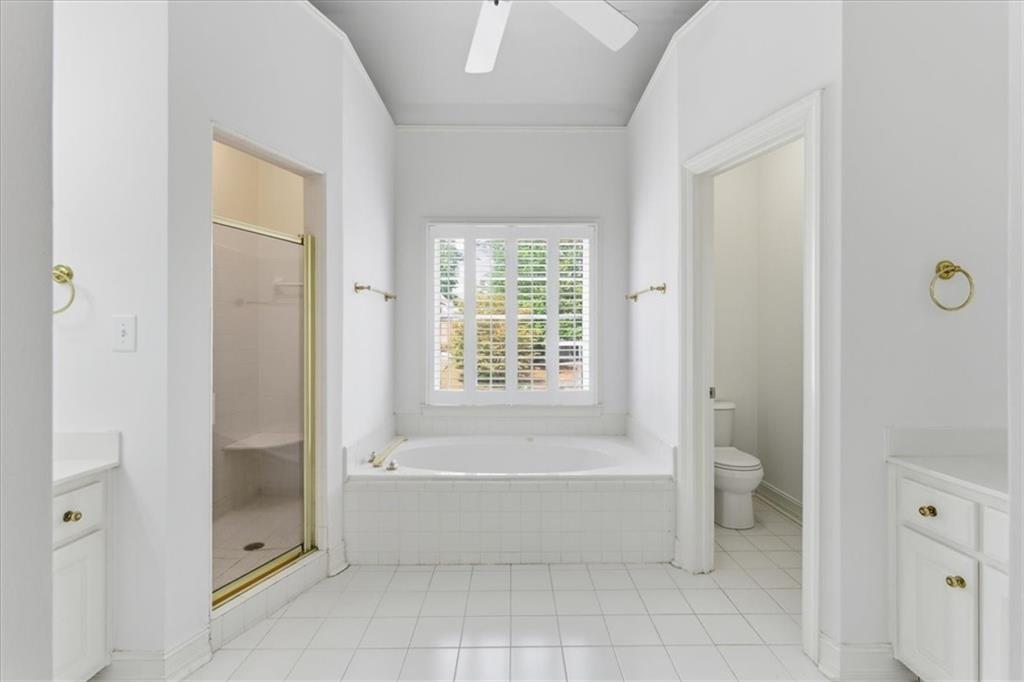 2021 Cockrell Pointe Northwest Kennesaw, GA 30152 - Photo 32 of 59 a spacious bathroom with a bathtub and a shower
