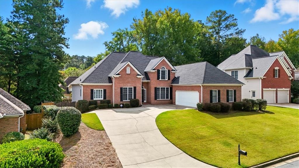 2021 Cockrell Pointe Northwest Kennesaw, GA 30152 - Photo 56 of 59 a front view of a house with a yard and trees