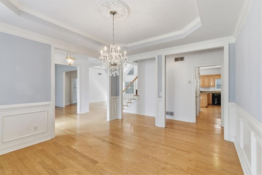 2021 Cockrell Pointe Northwest Kennesaw, GA 30152 - Photo 8 of 59 a view of a hallway with wooden floor and a chandelier
