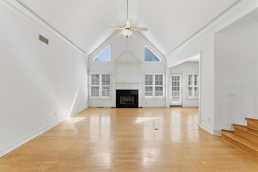 2021 Cockrell Pointe Northwest Kennesaw, GA 30152 - Photo 10 of 59 an empty room with wooden floor fireplace and windows