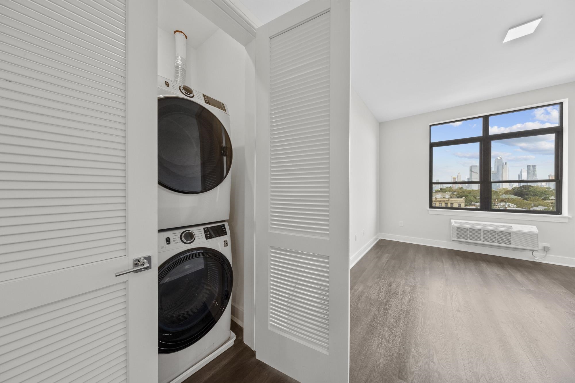 121 34th Street, Unit 604 Union City, NJ 07087 - Photo 14 of 44 a view of a kitchen with washer and dryer