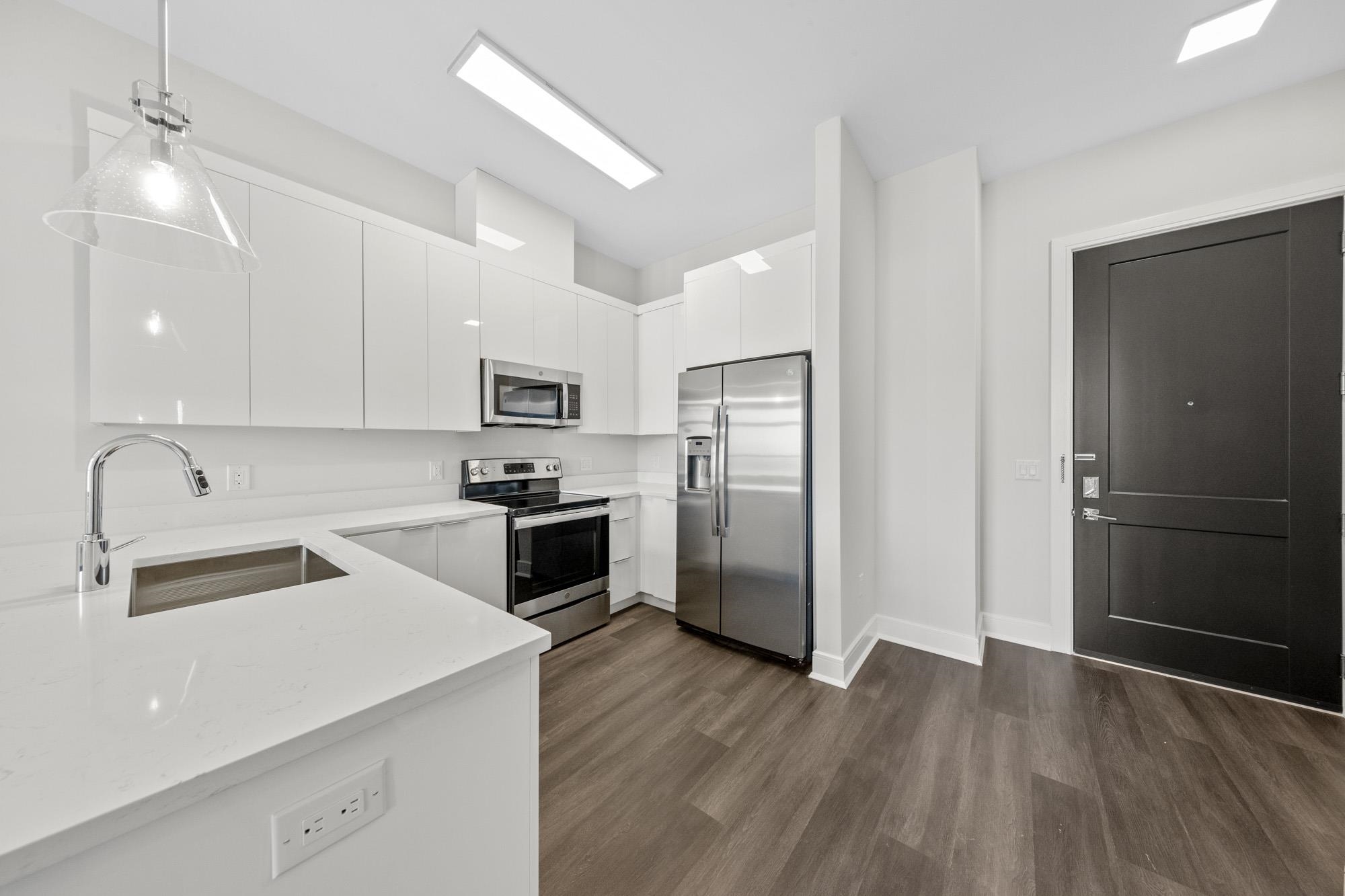 121 34th Street, Unit 604 Union City, NJ 07087 - Photo 5 of 44 a kitchen with granite countertop a refrigerator and a sink