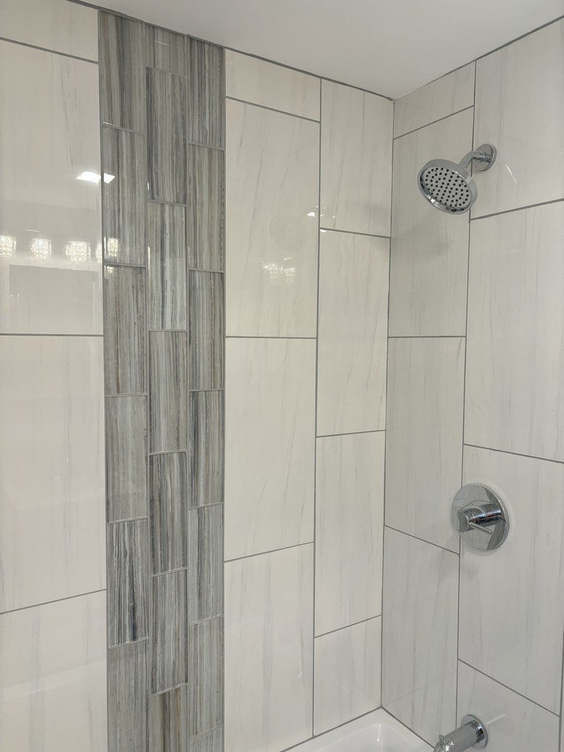 2049 East 93rd Street Chicago, IL 60617 - Photo 12 of 19 a bathroom with a shower and a glass door