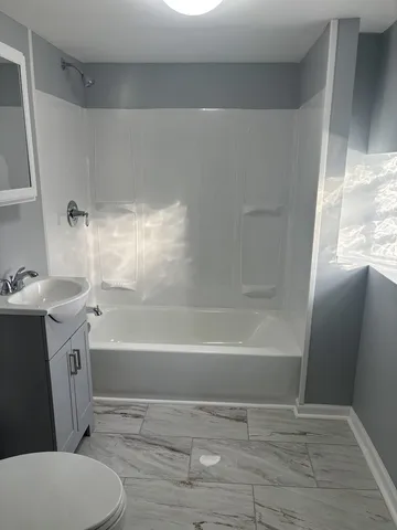 a bathroom with a sink toilet and bathtub