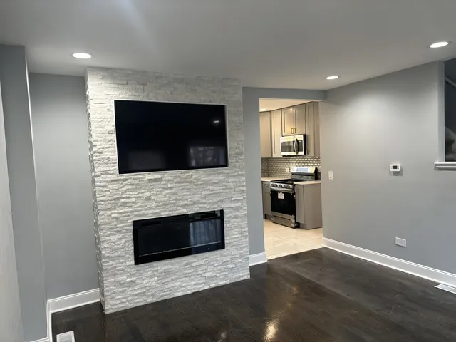 a living room with a fireplace and a television