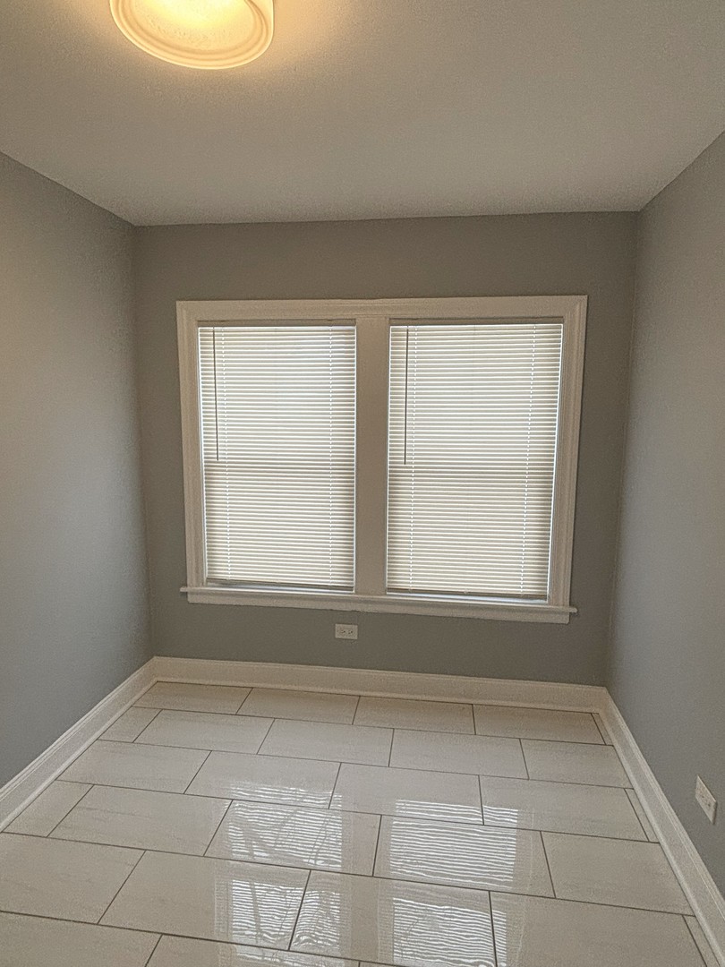 2049 East 93rd Street Chicago, IL 60617 - Photo 6 of 19 an empty room with a window