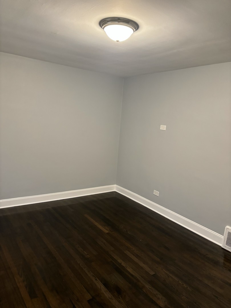 2049 East 93rd Street Chicago, IL 60617 - Photo 9 of 19 a view of an empty room with wooden floor