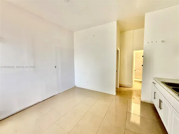 a view of a kitchen from the hallway
