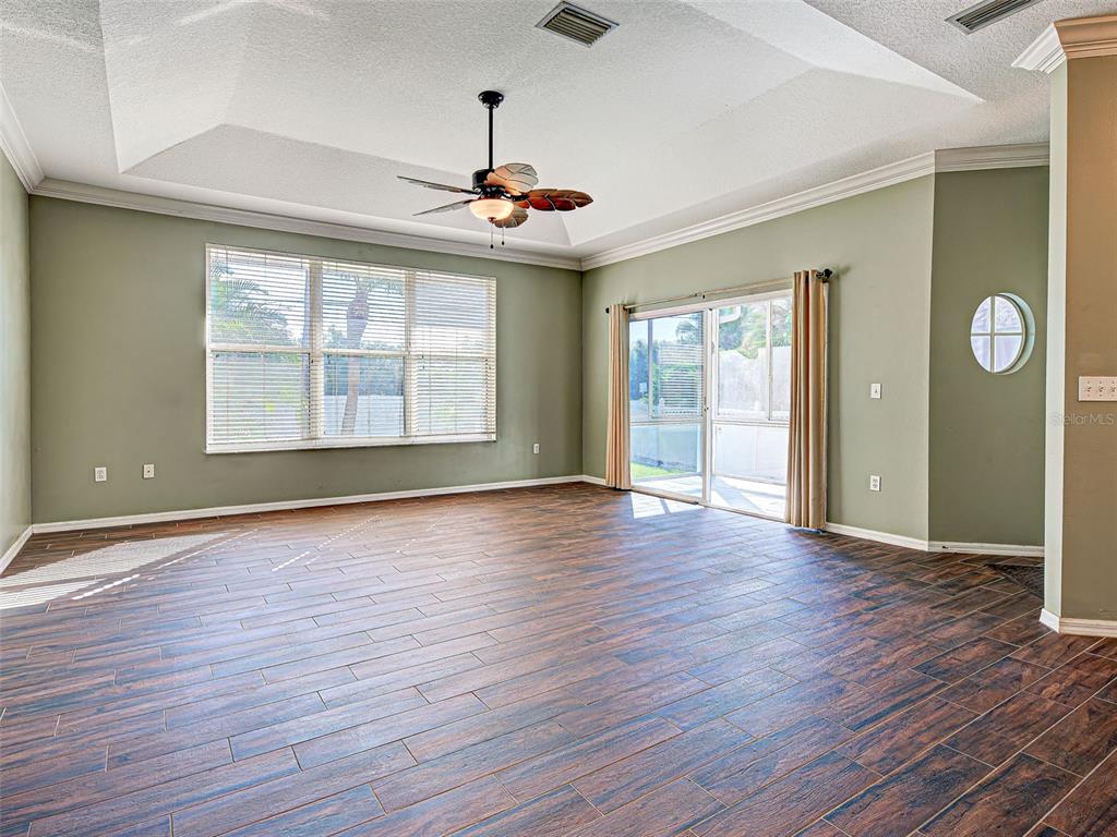 1801 Highland Road Osprey, FL 34229 - Photo 10 of 40 a view of an empty room with wooden floor and a window