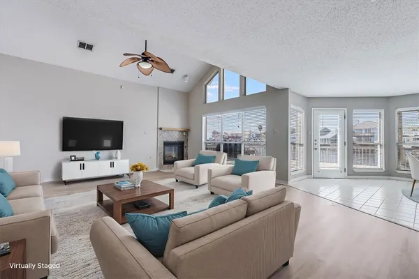 an empty room with wooden floor chandelier and windows