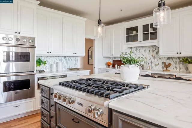 a white stove top oven sitting inside of a kitchen
