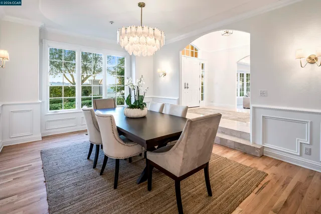 a view of a dining room with furniture wooden floor and chandelier