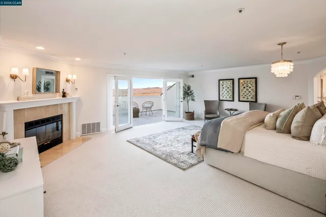 a spacious bedroom with a large bed and a fireplace