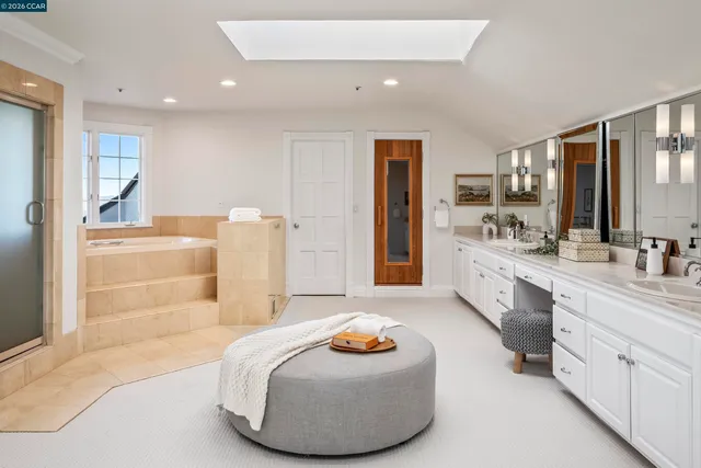 a bathroom with a tub sink and mirror
