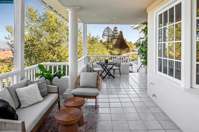 a living room with patio furniture and a large window