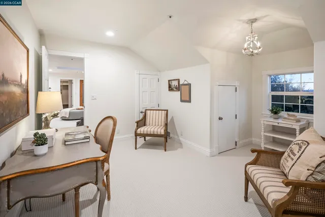 a living room with furniture a window and a chandelier