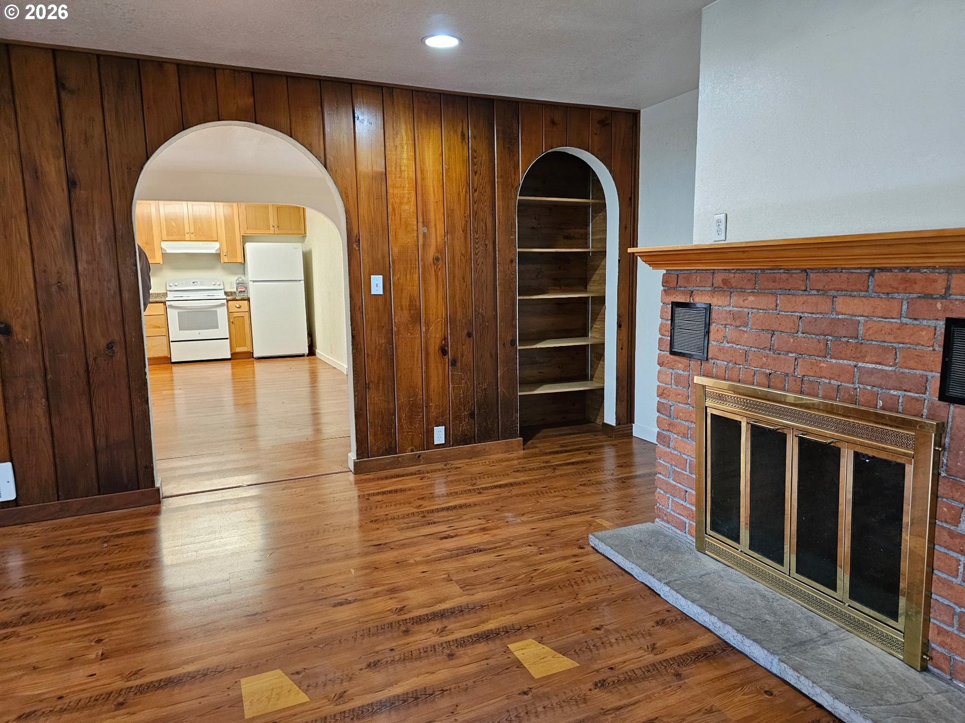 33802 Market Road Creswell, OR 97426 - Photo 7 of 30 a view of an empty room with wooden floor and a fireplace