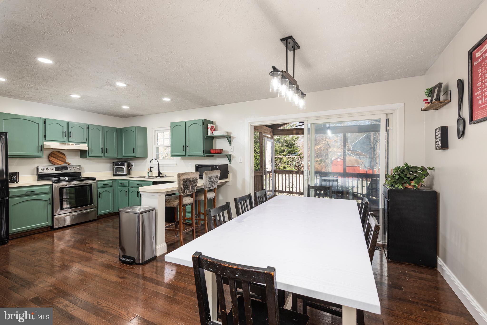 48 Fox Run Way Arnold, MD 21012 - Photo 18 of 33 a kitchen with stainless steel appliances granite countertop a refrigerator a stove top oven a sink dishwasher and white cabinets with wooden floor