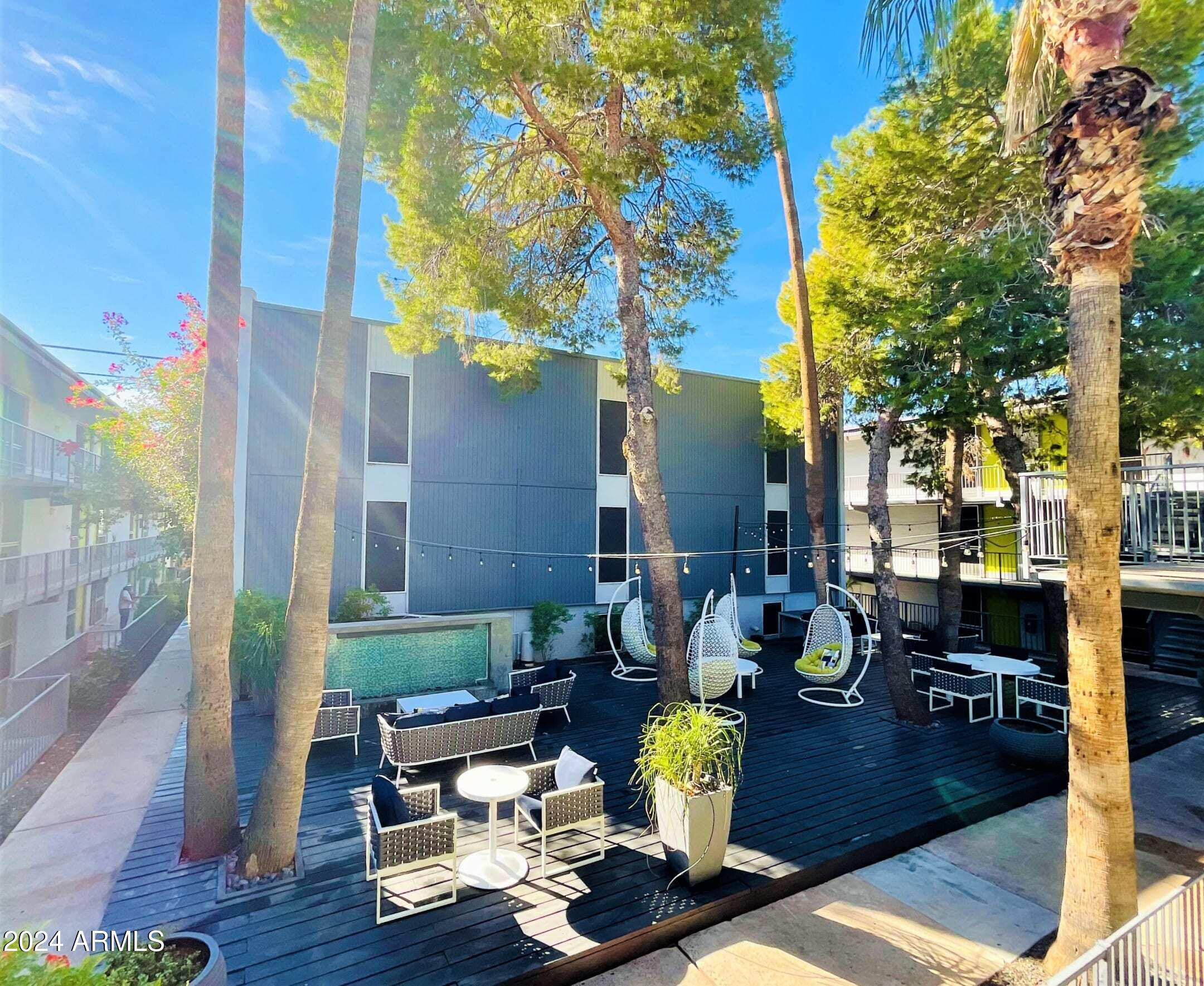 1601 West Camelback Road, Unit E10AE Phoenix, AZ 85015 - Photo 11 of 22 a building outdoor space with patio furniture and wooden floor