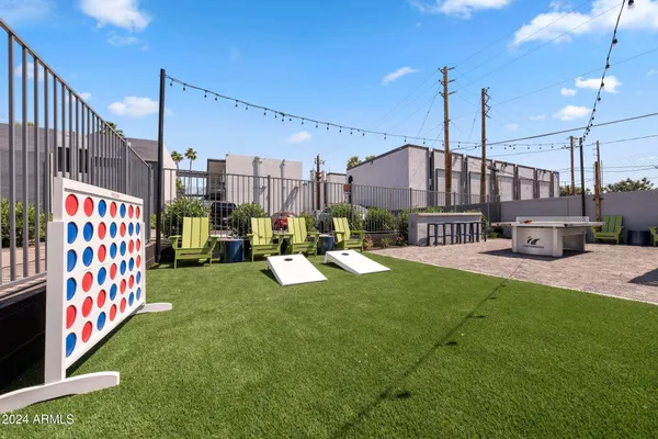 a view of a patio with furniture and umbrella