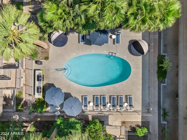 a view of a swimming pool with outdoor seating