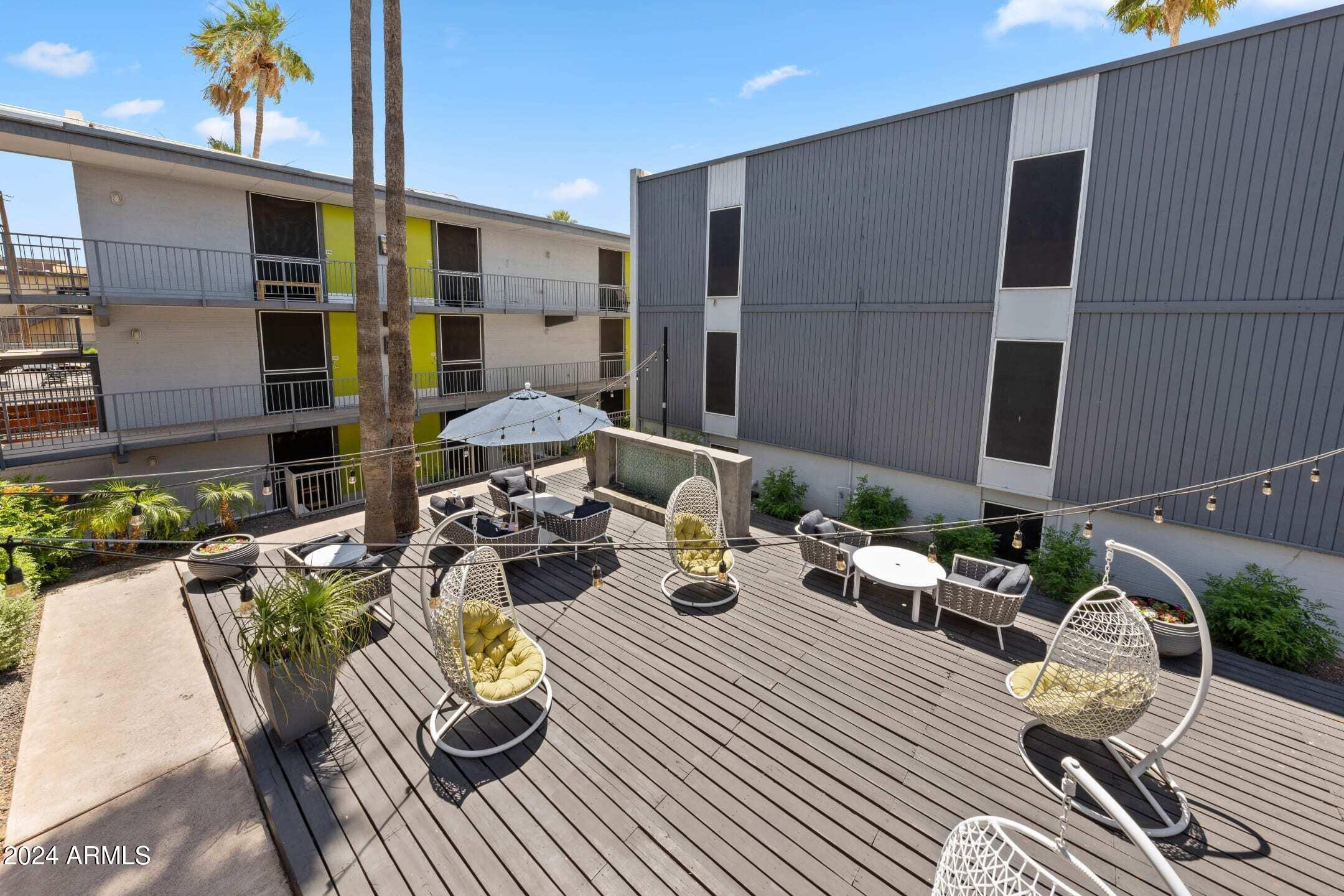 1601 West Camelback Road, Unit E10AE Phoenix, AZ 85015 - Photo 10 of 22 a view of a patio with couches table and chairs and potted plants