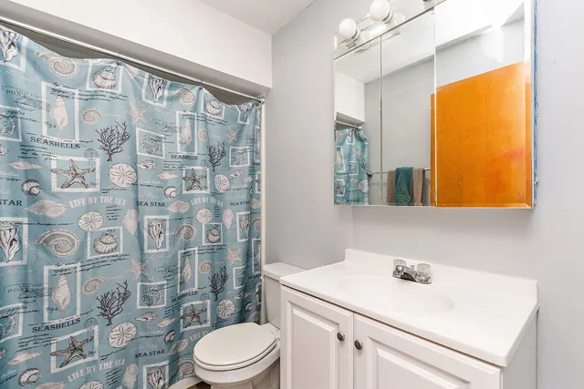 a bathroom with a sink toilet and shower