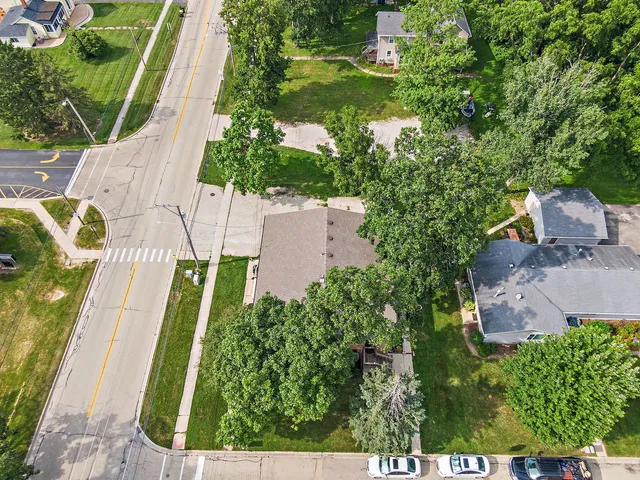 an aerial view of residential house with outdoor space and trees all around