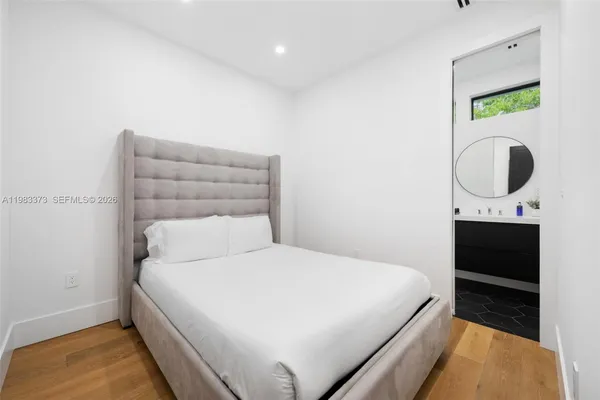 a bedroom with a bed and a night stand