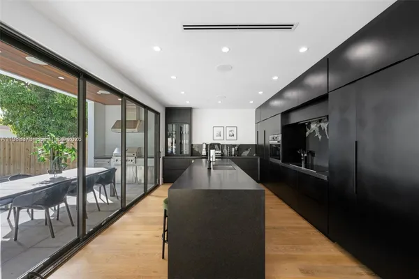 a view of a living room and balcony with furniture