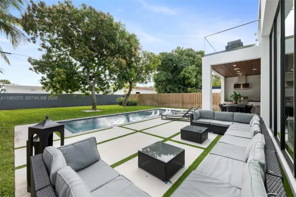 swimming pool view with a seating space