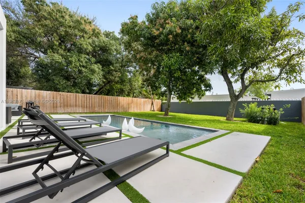 a view of a backyard with sitting area