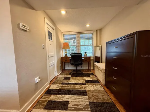 a living room with furniture and a rug