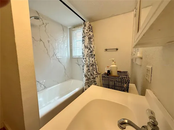 a bathroom with a bathtub and shower