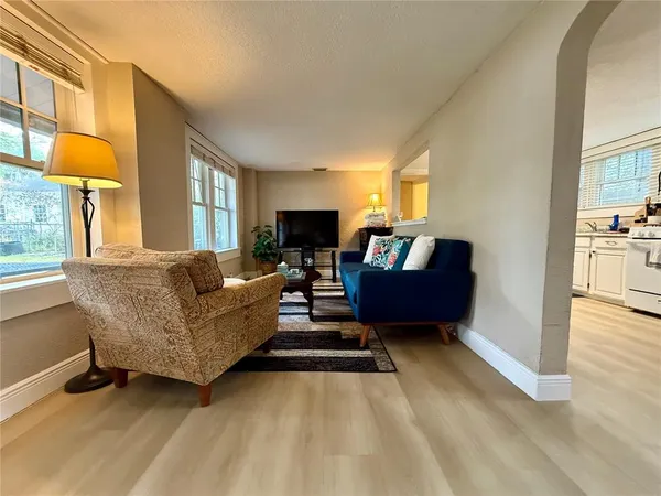 a living room with furniture and a lamp