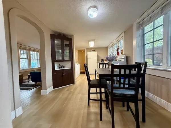 a view of a dining room with furniture and a large window