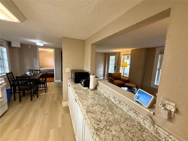 a living room with furniture a dining table and a fireplace