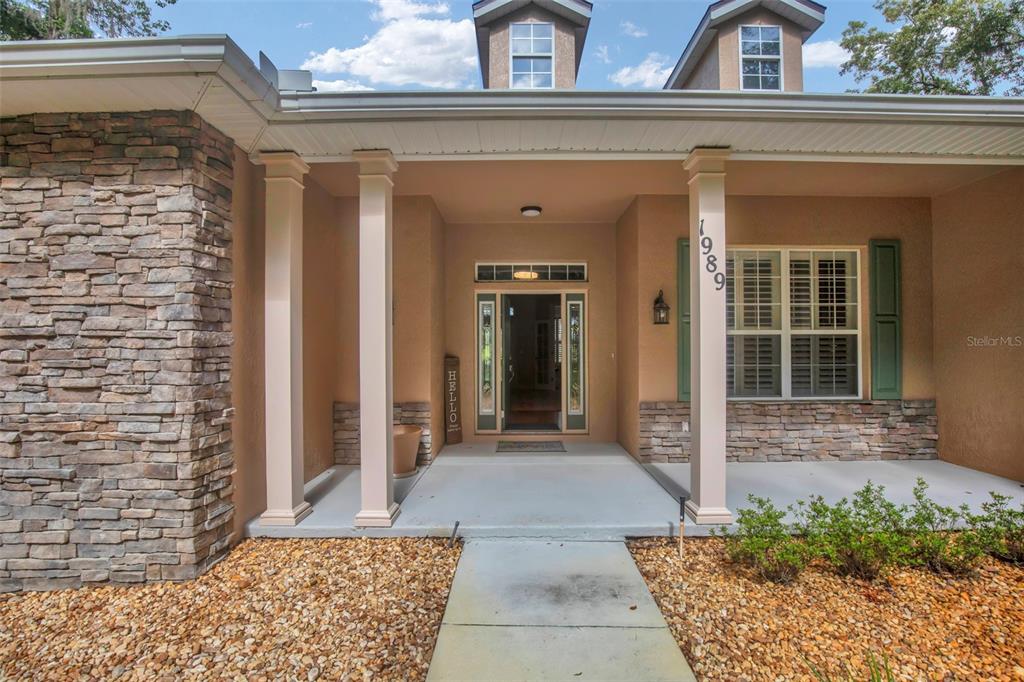 1989 Northwest 111th Loop Ocala, FL 34475 - Photo 7 of 55 front view of a house with a glass door