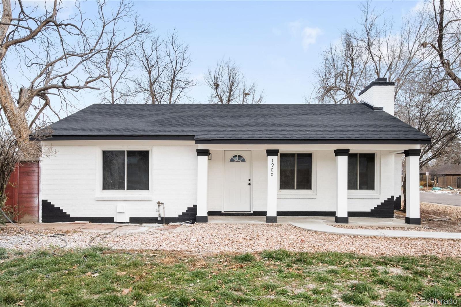 1900 Quebec Street Denver, CO 80220 - Photo 1 of 15 a front view of a house with a yard and garage