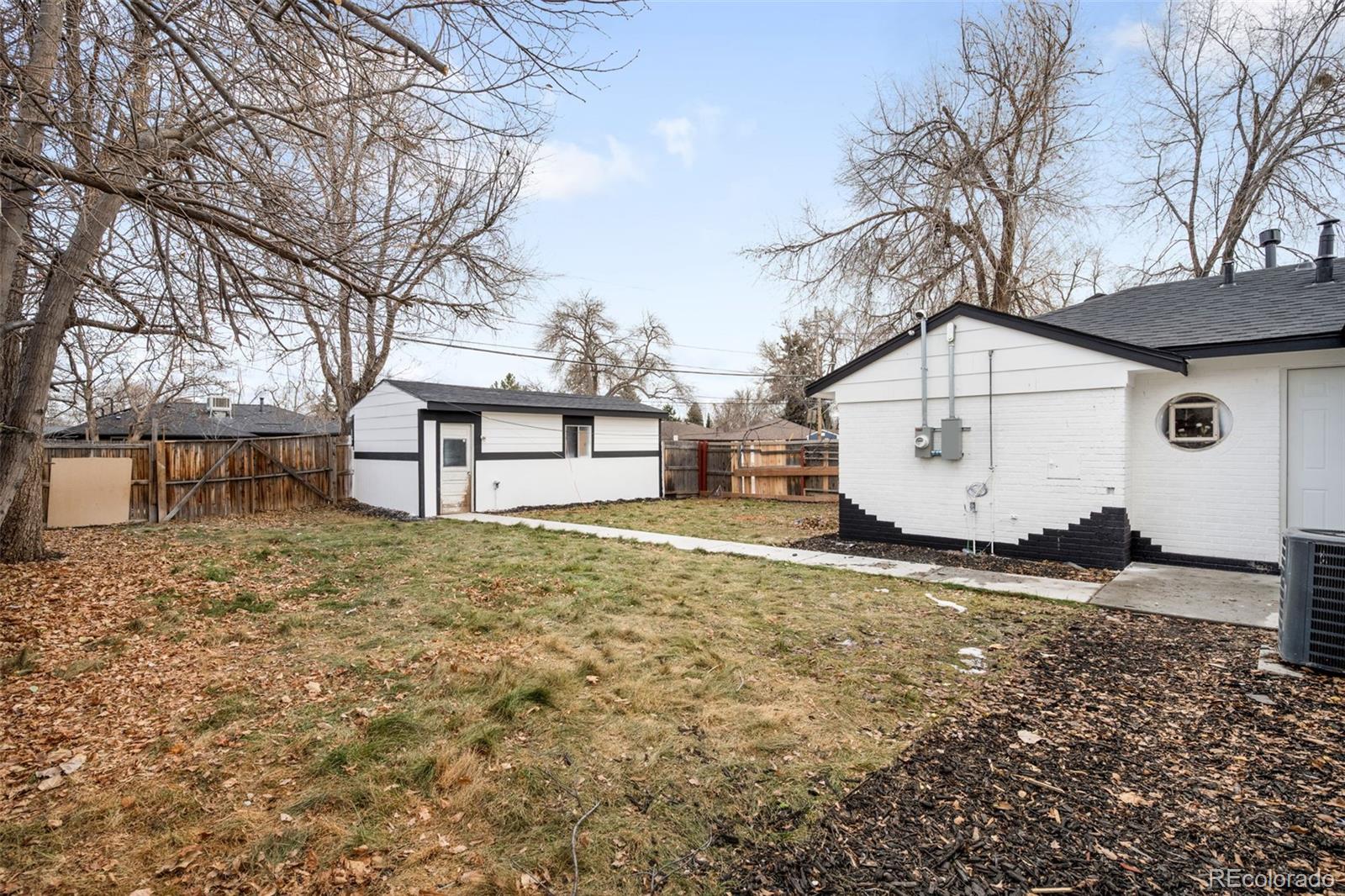 1900 Quebec Street Denver, CO 80220 - Photo 15 of 15 a backyard of a house with large trees and barbeque oven